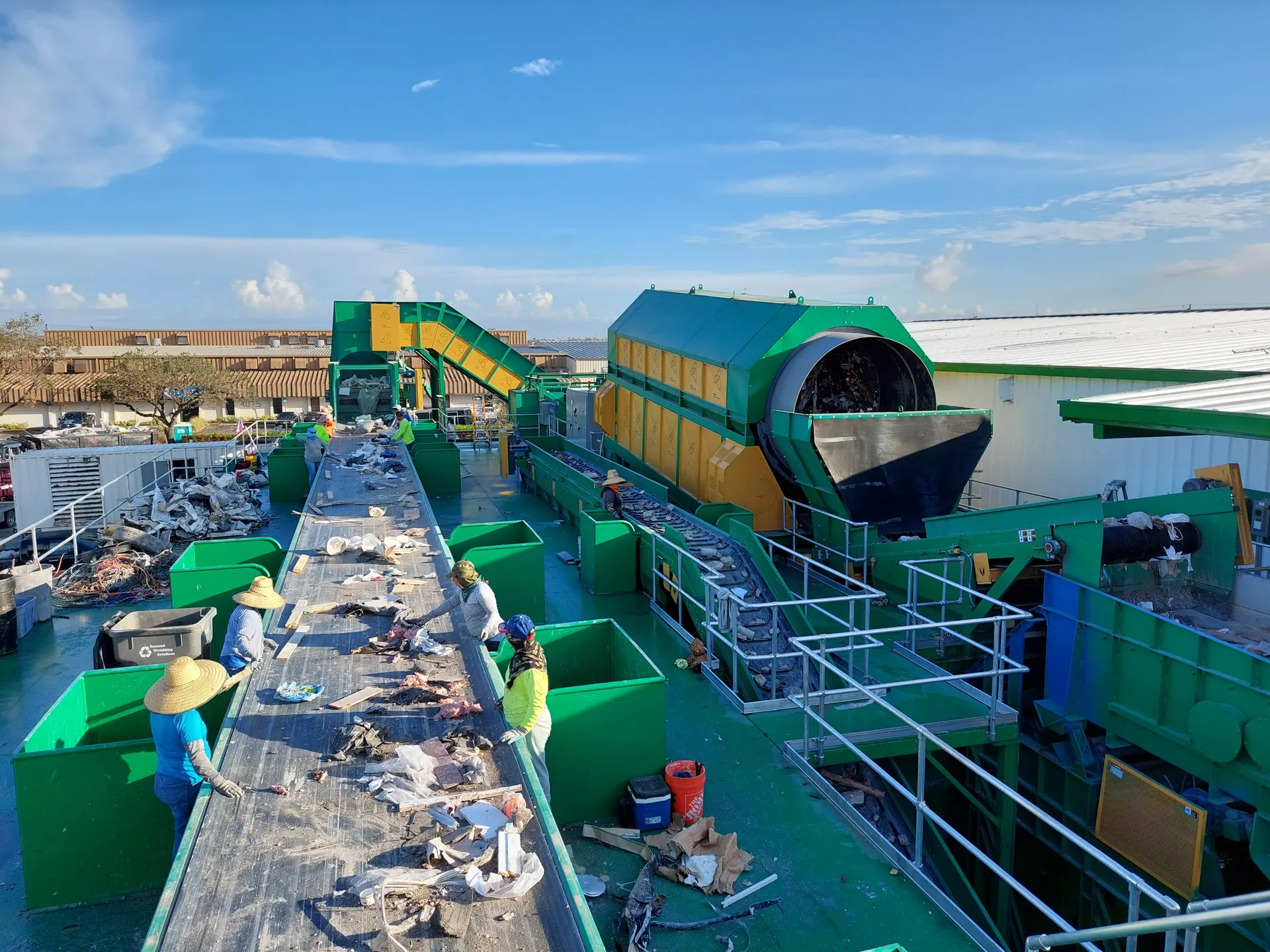 C&D sorting line in operation with trommel and picking conveyor