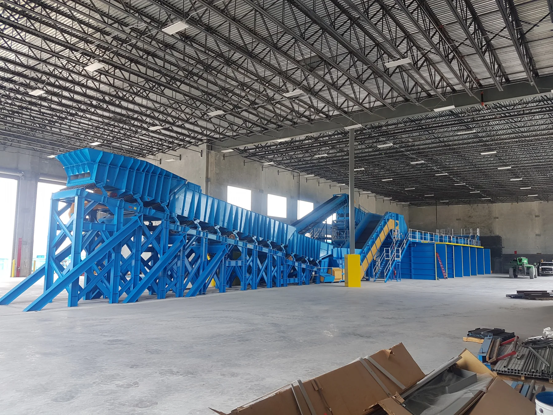 Blue sorting line and conveyors installed inside a plant building