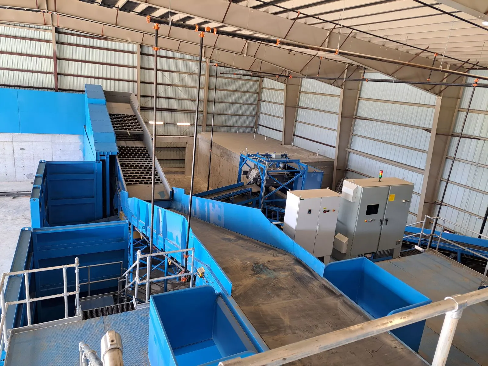 Sorting line with bunkers and controls inside a processing facility